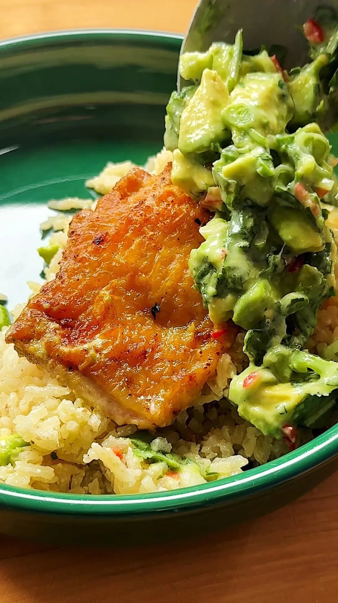 ONE PAN COCONUT LIME CHICKEN AND RICE with avocado salsa — a light, simple meal that doesn’t shy away from bright, citrusy flavors. Golden chicken thighs seared in @latourangelle avocado oil, fluffy coconut lime rice and a creamy avocado coconut salsa: Dump it all together in one pan and dinner is ready! #latourangellepartner 

Ingredients (4 servings)

1 cup jasmine rice
5 to 6 skin-on chicken thighs 
1 chicken bouillon cube, crushed 
Salt and black pepper
4 tablespoons avocado oil
1 cup canned coconut milk, plus 2 tablespoons for topping 
1 cup water 
Zest and juice of one lime, plus 1 lime for topping 
6 garlic cloves, peeled 
2-inch ginger knob, sliced
1 large avocado, peeled and cubed
1 hot peppers, finely diced, such as Serrano or Fresno
1 bunch cilantro, chopped 
3 scallions, thinly sliced 

Heat the oven to 425°F (215°C). 

Thoroughly wash the rice. Set aside to drain.  Pat dry the thighs using a paper towel. Add to a bowl alongside the bouillon cube, salt and pepper. Add the avocado oil and toss to evenly coat. 

Heat a 12-inch skillet over medium heat. Place the chicken skin-side down and cook for 6 to 8 minutes, until golden. Adjust the heat as needed. Flip and cook for 4 minutes. Transfer the chicken to a clean plate.

To the skillet, add the rice and toast, stirring occasionally, for 4 to 6 minutes, until lightly golden. Carefully add the water, 1 cup coconut milk, zest and juice of 1 lime, garlic, ginger and a big pinch of salt. Place the chicken, skin side-up in the skillet and any leftover juices from the plate. 

Bring to a simmer and cover with a lid. Place in the oven for 15 minutes. Turn off the oven and allow the skillet to sit, with the lid on, for 10 more minutes in the oven. Broil before serving to crisp up the chicken skin, if you like. 

Meanwhile, make the topping: In a mixing bowl, combine the avocado, pepper, cilantro, scallions, remaining 2 tablespoons coconut milk and juice of 1 lime. Season with salt and add dollops of the mixture to the skillet, before serving. 

#dinner #onepanmeal #chicken #rice